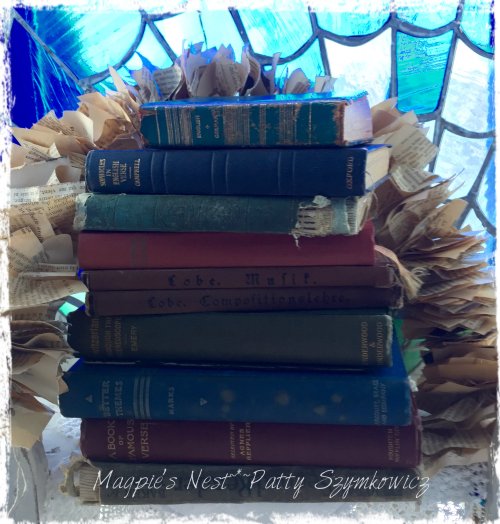 small stack of old books and garland